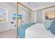 Bedroom with a queen bed, dresser, and large TV at 518 Spring Ave, Anna Maria, FL 34216