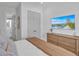 Spacious bedroom with ensuite bathroom and large TV at 518 Spring Ave, Anna Maria, FL 34216