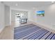 Bright game room with light wood floors and sliding glass doors at 518 Spring Ave, Anna Maria, FL 34216