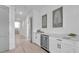 Bright hallway with built-in bar and wine cooler at 518 Spring Ave, Anna Maria, FL 34216