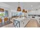 Open concept kitchen with white cabinets, marble countertops, and a breakfast bar at 518 Spring Ave, Anna Maria, FL 34216