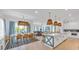 Open concept kitchen with island, dining area, and high end finishes at 518 Spring Ave, Anna Maria, FL 34216