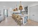 Modern kitchen with white cabinets, blue tile backsplash, and a large island at 518 Spring Ave, Anna Maria, FL 34216