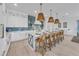 Modern kitchen with white cabinets, a large island, and blue tile backsplash at 518 Spring Ave, Anna Maria, FL 34216