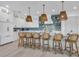 Modern kitchen with white cabinets, blue tile backsplash, and a large island at 518 Spring Ave, Anna Maria, FL 34216