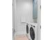 Convenient laundry room with washer, dryer, and blue cabinets at 518 Spring Ave, Anna Maria, FL 34216