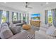 Bright living room featuring a sectional sofa and coastal decor at 518 Spring Ave, Anna Maria, FL 34216