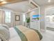 Main bedroom with a four-poster bed, en-suite bathroom access, and a large TV at 518 Spring Ave, Anna Maria, FL 34216