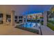 Luxury pool and spa with built-in seating and colorful tile at 518 Spring Ave, Anna Maria, FL 34216