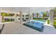 Inviting pool and spa area with covered patio and lounge chairs at 518 Spring Ave, Anna Maria, FL 34216