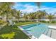 Inviting pool area with putting green, lounge chairs, and lush landscaping at 518 Spring Ave, Anna Maria, FL 34216