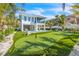 Expansive putting green in a tropical backyard setting at 518 Spring Ave, Anna Maria, FL 34216
