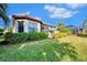 Landscaped backyard with lush lawn and home view at 5401 Manchini St, Sarasota, FL 34238