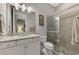 Clean bathroom with shower/tub combo, granite countertop, and white cabinets at 5401 Manchini St, Sarasota, FL 34238