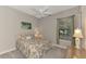 Cozy bedroom with a floral comforter and a ceiling fan at 5401 Manchini St, Sarasota, FL 34238
