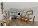 Open concept dining room with hardwood floors and access to the living room at 5401 Manchini St, Sarasota, FL 34238