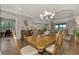 Bright dining room featuring a large wood table and access to the kitchen at 5401 Manchini St, Sarasota, FL 34238