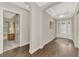 Bright and airy entry hall with hardwood floors and views into other rooms at 5401 Manchini St, Sarasota, FL 34238