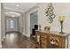 Entryway with hardwood floors and an antique console table at 5401 Manchini St, Sarasota, FL 34238