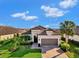 Single-story home with tile roof, 2-car garage, and landscaped yard at 5401 Manchini St, Sarasota, FL 34238