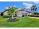 Single-story home with tile roof, 2-car garage, and palm trees at 5401 Manchini St, Sarasota, FL 34238
