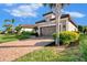 Single story home with a 2-car garage and lush landscaping at 5401 Manchini St, Sarasota, FL 34238