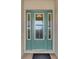 Elegant teal front door with sidelights and etched glass at 5401 Manchini St, Sarasota, FL 34238