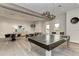 Game room with ping pong table and comfortable seating at 5401 Manchini St, Sarasota, FL 34238