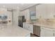 Modern kitchen featuring white cabinets, granite counters, and stainless steel appliances at 5401 Manchini St, Sarasota, FL 34238