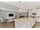 Open concept kitchen with large island, breakfast bar, and Gathering room view at 5401 Manchini St, Sarasota, FL 34238