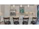 Modern kitchen with white cabinets, stainless steel appliances, and breakfast bar at 5401 Manchini St, Sarasota, FL 34238