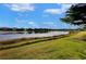 Scenic view of lakefront property with lush grass at 5401 Manchini St, Sarasota, FL 34238