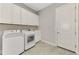 Clean laundry room with white cabinets and appliances at 5401 Manchini St, Sarasota, FL 34238