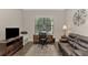 Home office with built-in desk, leather couch, and large window at 5401 Manchini St, Sarasota, FL 34238