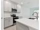Modern kitchen with gray cabinets, stainless steel appliances, and white countertops at 5447 Tripoli Dr, Palmetto, FL 34221