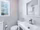 Small bathroom with white vanity and toilet, featuring a window at 5544 Dinah Ln, Sarasota, FL 34231