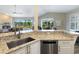 Kitchen corner sink with granite countertops and stainless steel appliances at 5544 Dinah Ln, Sarasota, FL 34231