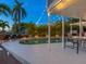 Inviting pool area with string lights and lounge chairs at dusk at 5544 Dinah Ln, Sarasota, FL 34231