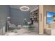Elegant home office features built-in shelving, glass desk, and a calming color palette at 555 Quay Cmn # 1105, Sarasota, FL 34236