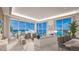 Living area with floor-to-ceiling windows showcasing stunning water views at 555 Quay Cmn # 1105, Sarasota, FL 34236