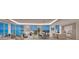 Open concept living space with panoramic water views and modern furnishings at 555 Quay Cmn # 1105, Sarasota, FL 34236