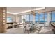 Elegant dining room with water views and glass table at 555 Quay Cmn # Ph2002, Sarasota, FL 34236