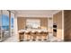 Modern kitchen with wood cabinets and island seating at 555 Quay Cmn # Ph2002, Sarasota, FL 34236