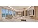 Spacious living room with water views and modern furniture at 555 Quay Cmn # Ph2002, Sarasota, FL 34236