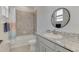 Bathroom with gray tile, granite vanity, and a tub shower combo at 5755 Woodland Sage Dr, Sarasota, FL 34238