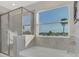 Bathroom with soaking tub, shower, and a window with a view at 5755 Woodland Sage Dr, Sarasota, FL 34238