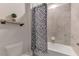 Clean bathroom with a tub and patterned shower curtain at 5755 Woodland Sage Dr, Sarasota, FL 34238