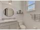 Small bathroom with granite countertop, gray vanity, and white toilet at 5755 Woodland Sage Dr, Sarasota, FL 34238