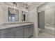 Bathroom boasts double vanity with gray cabinets and a shower/tub combo at 5755 Woodland Sage Dr, Sarasota, FL 34238