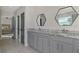Double vanity bathroom with granite countertop and grey cabinets at 5755 Woodland Sage Dr, Sarasota, FL 34238